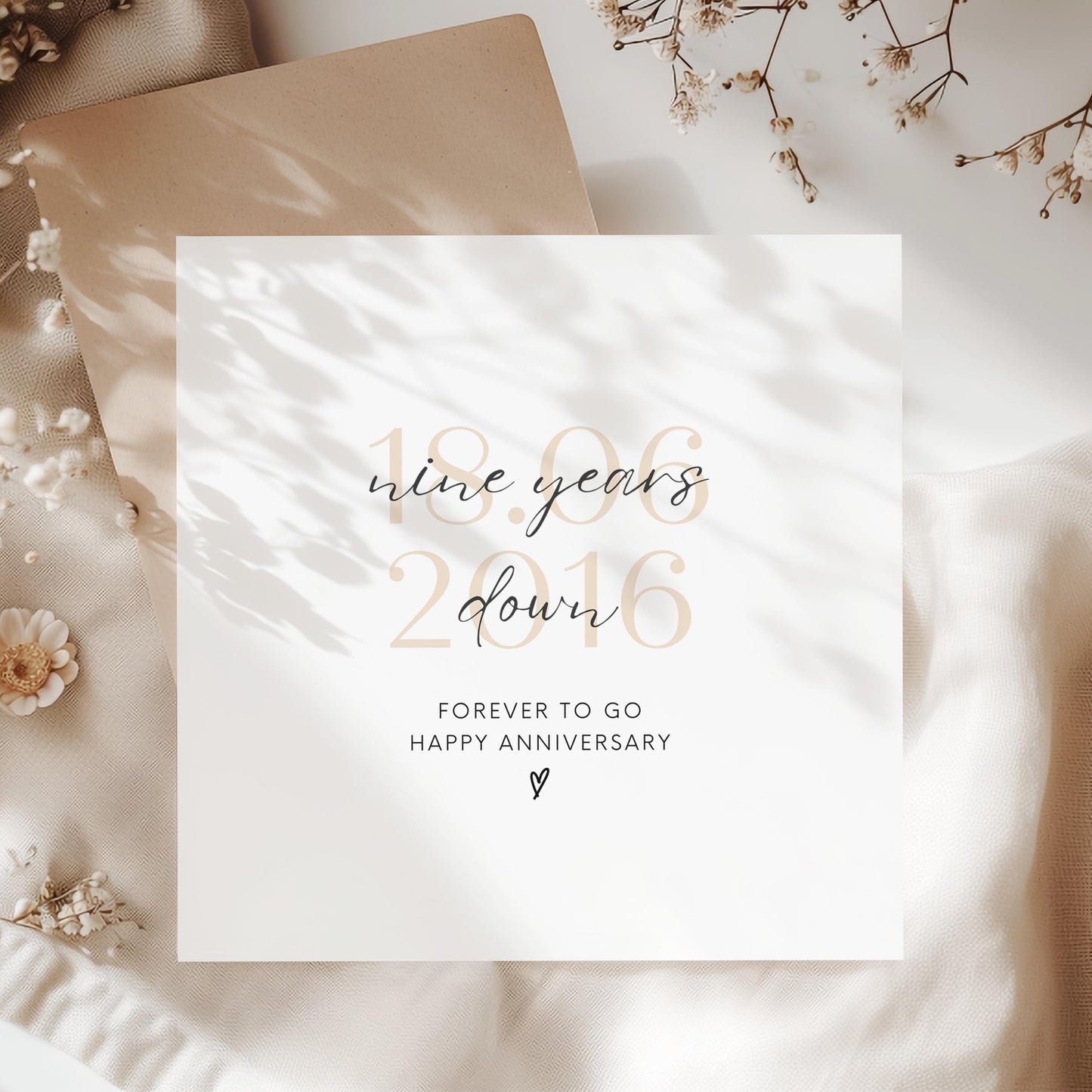 Personalised nine-year anniversary card featuring soft beige date, script text reading “Nine Years Down”, and a small heart detail.