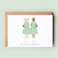 A personalised &#39;Will You Be My Flower Girl Twins&#39; card featuring customised dresses, skin tones, and hairstyles for the twin flower girls, along with custom text.