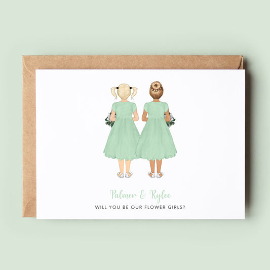 A personalised &#39;Will You Be My Flower Girl Twins&#39; card featuring customised dresses, skin tones, and hairstyles for the twin flower girls, along with custom text.