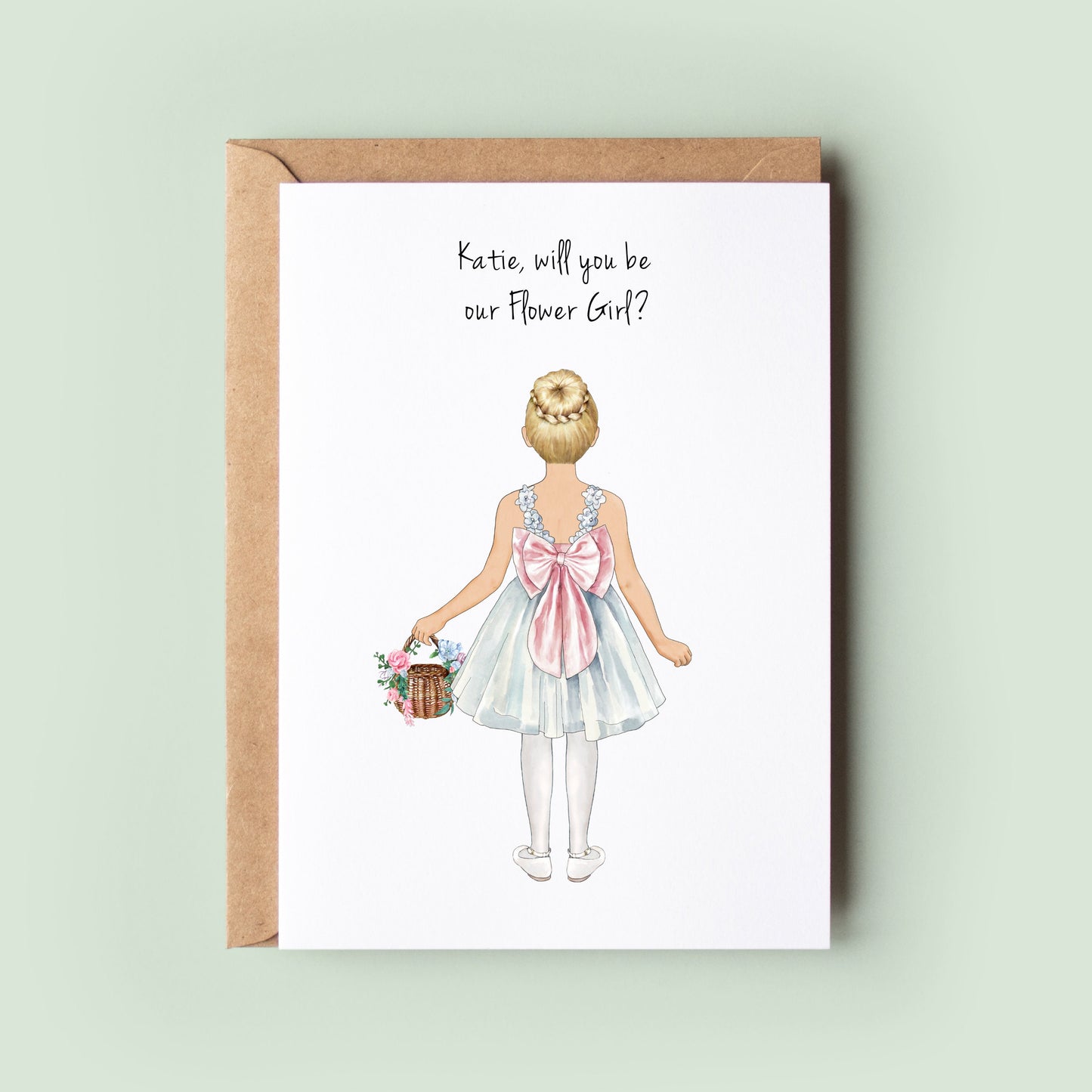 A close-up of a personalised Will You Be My Flower Girl, Will You Be My Junior Bridesmaid card featuring custom illustrations for the flower girl&#39;s dress, skin tone, and hairstyle.