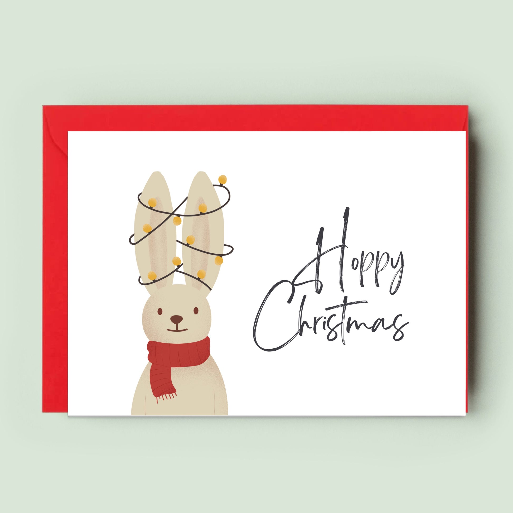 Charming &#39;Hoppy Christmas&#39; Card featuring a joyful hopping bunny, perfect for spreading festive cheer among family, friends, and loved ones of all ages.