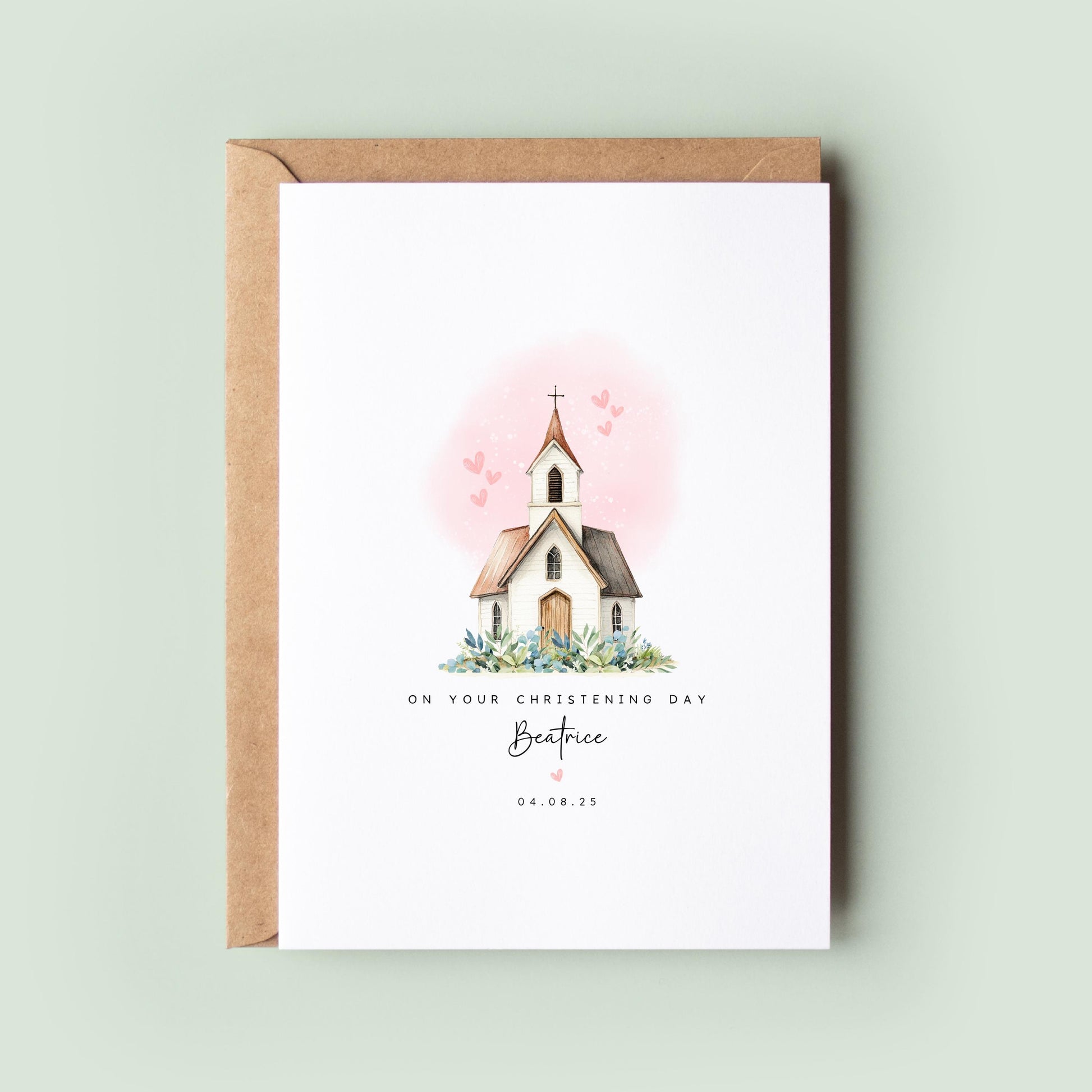 Personalised christening card featuring an illustrated white church with a cross and soft pink hearts in the background. The text reads “On your Christening Day,” followed by the name and date. Comes with a recycled kraft envelope.