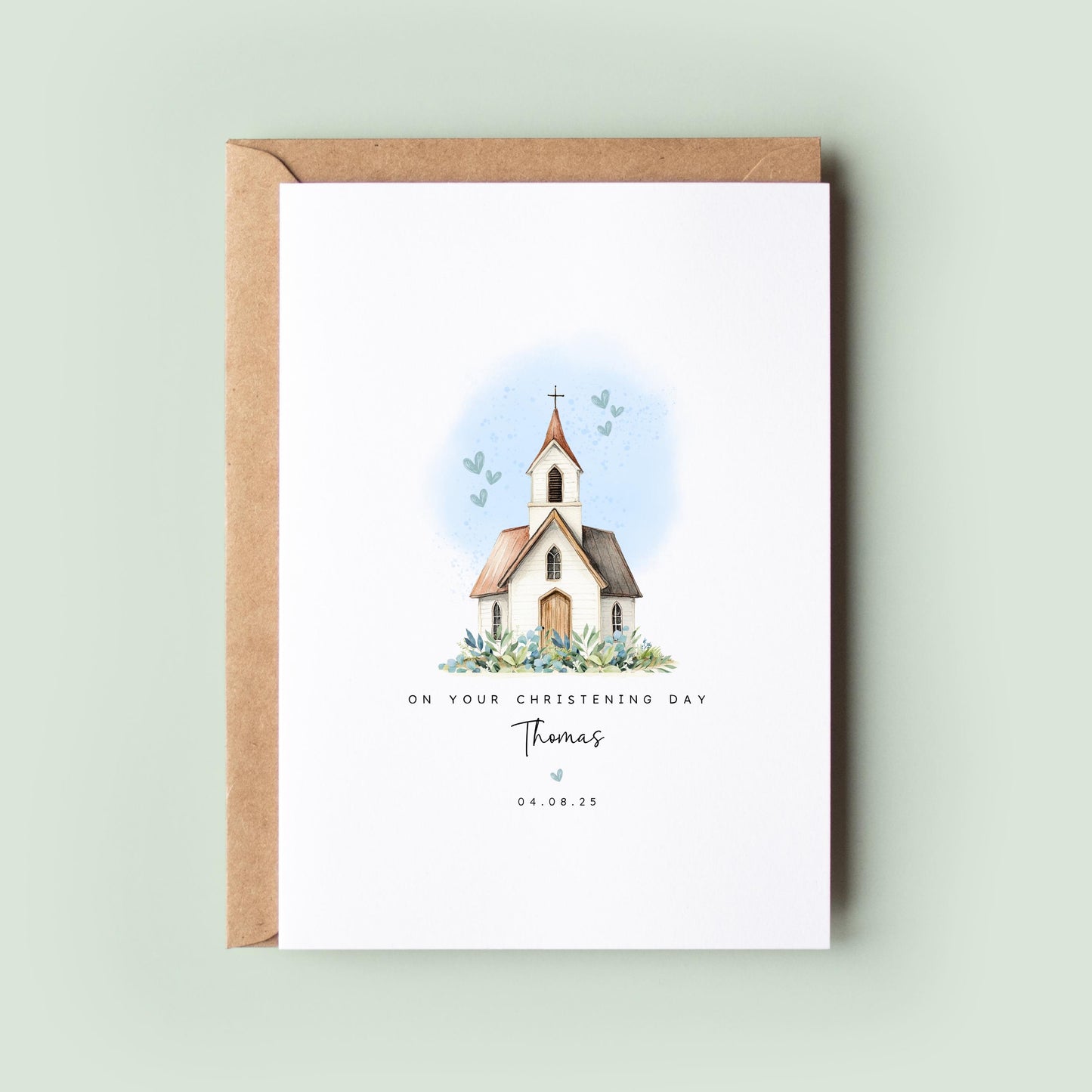 Personalised christening card featuring an illustrated white church with a cross and soft blue hearts in the background. The text reads “On your Christening Day,” followed by the name and date. Comes with a recycled kraft envelope.