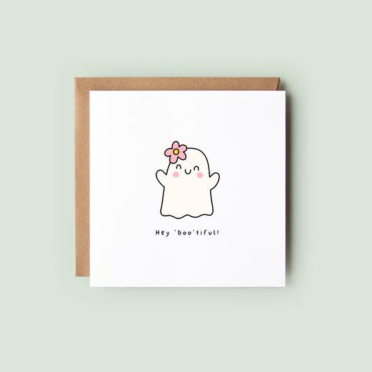Cute Halloween card with ghost illustration, pink flower, and the phrase “Hey Boo’tiful!”
