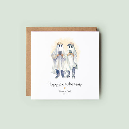 Personalised linen anniversary card featuring two male ghosts holding phones in a humorous Halloween-style design, with names and anniversary date.